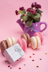 colored macaroons on a pink background