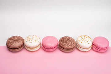 colored macaroons on a pink background