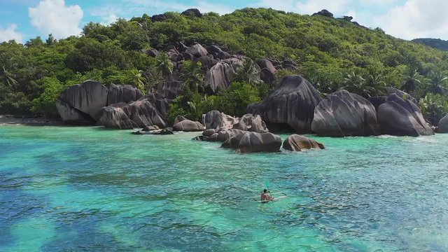 Aerial drone view on the beautiful white sand rocky beach in the seychelles, La digue silver bay