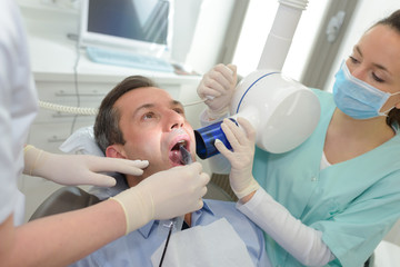 dentist taking x-ray of patients teeth