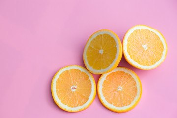 Obraz na płótnie Canvas Slice of fresh orange isolated on pink background view