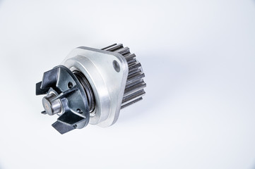 New metal automobile pump for cooling the engine of a water pump on a gray background. The concept of new spare parts for the car engine