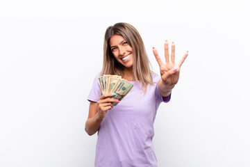 young pretty woman smiling and looking friendly, showing number three or third with hand forward,...