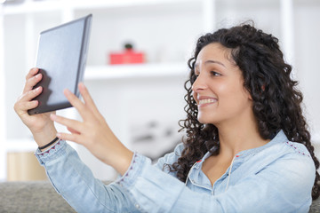 woman chatting to her long distance boyfriend using a tablet