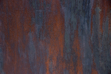 Background interesting rusty wall with scratches. Dark red, red, blue, purple, dark turquoise
