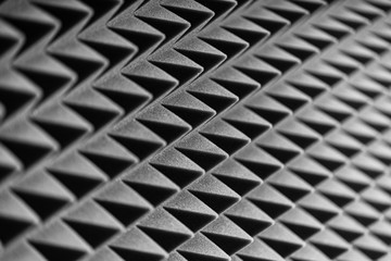 Grey acoustic foam pyramid repeating background for music Studio. Black and white.