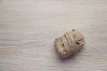 Skein of twine, rope on a beige wooden background.  Flat Lay