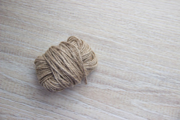 Skein of twine, rope on a beige wooden background.  Flat Lay