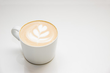 coffee with heart pattern on the foam in white cup