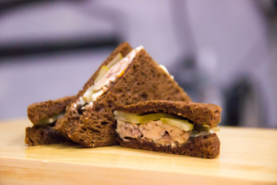Fishy club sandwiches served on a chopping board