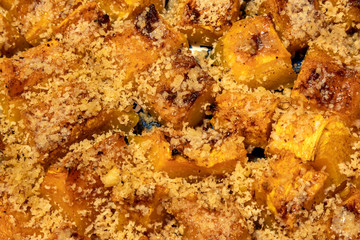 The surface of fresh baked pumpkin with honey and chopped nuts