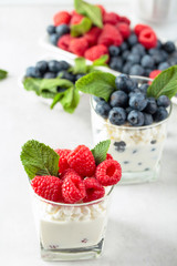 Cottage cheese with cream, raspberry and blueberry .