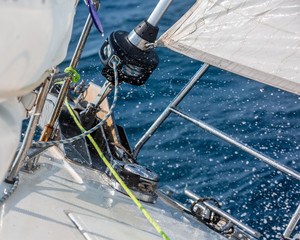 Sailing boat in the high sea, sailing rope, water spray