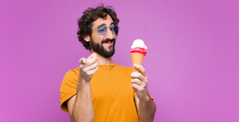 young crazy cool man having an ice cream against purple wall