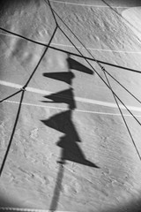 Black and white image of sailing boat sails, flag shadow on sailing boat sails