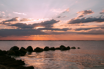 sea image with stones and sun rays