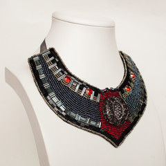 colored handmade jewelry made of beads, stones and metal on a white background