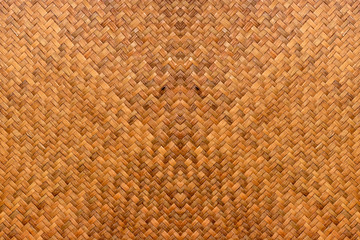 pattern of brown woven reed mat texture background, basketry crafted by Thai people.
