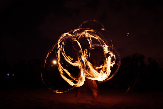 fire dancer AGAINST SKY AT NIGHT
