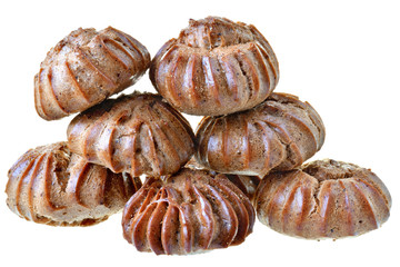 Heap of freshly baked brown eclairs isolated