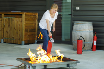 woman is extinguishing fire drill