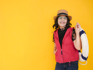 Senior woman 60 years old traveler in studio isolated on yellow background. summer concept