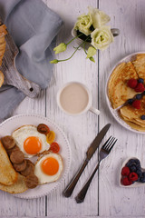 Breakfast with pancakes and fried eggs