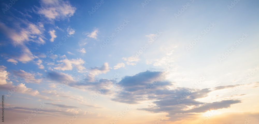 Wall mural blue sky clouds background. beautiful landscape with clouds and orange sun on sky