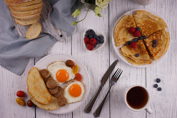 Breakfast with pancakes and fried eggs