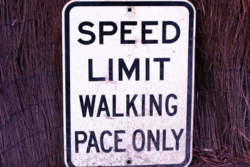 Traffic sign on the wall "Speed limit - walking pace only"