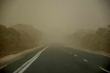 A dust storm on the road near Mildura, Australia. Dust particles in the air cause low visibility