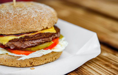 burger closeup on wooden table. fast food