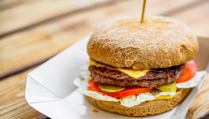 burger closeup on wooden table. fast food