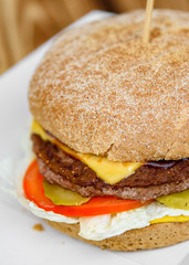 burger closeup on wooden table. fast food
