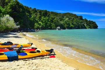 Kayaks on the beach of the Abel Tasman National Park. New Zealand, South Island.
