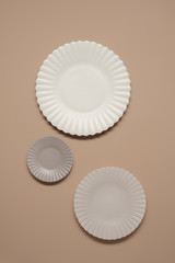Beautiful plates pastel color top view.  Empty plates on beige background 