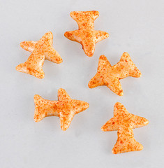 Fried and Spicy Aero Plane Snacks or Fryums (Snacks Pellets) served in a bowl or White background. selective focus - Image