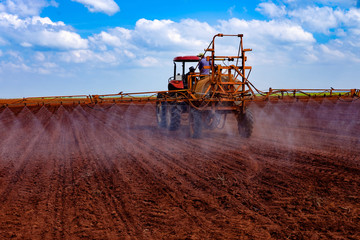 Tractor spraying the lands for weeds