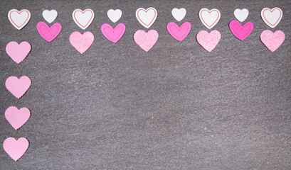 gray granite background with pink and white hearts for valentines day. Valentine's day and love concept