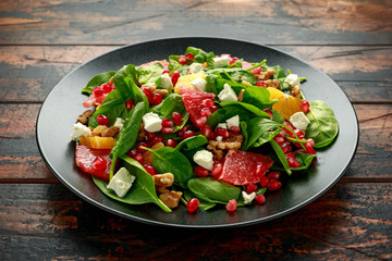 Orange Grapefruit salad with spinach, walnuts, pomegranate seeds and feta cheese. healthy food