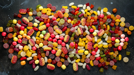 A mix of colorful candy on background, texture