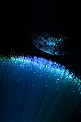 abstract background with colored fibers optics reflected on glass sphere