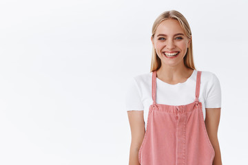 Cheerful, enthusiastic caucasian blond woman in casual outfit give customers sincere friendly smile...