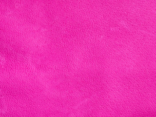 Background with leather texture. Pink piece of natural tanned calfskin painted and treated with fuchsin paint. Lots of detail, frontal shot with macro lens. Copyspace for border or frame