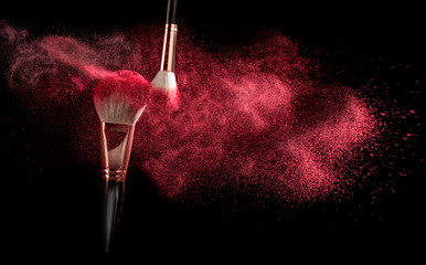 powder explosion with make-up brush on black ground