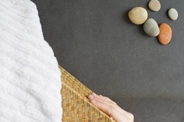Spa and sauna concept with towel, rocks and tiki basket