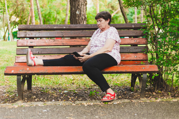 Senior woman using mobile phone outside