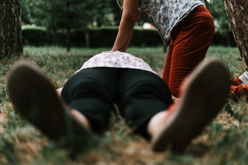 Young person giving CPR to senior woman