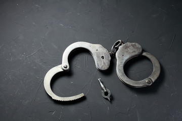 police handcuffs on a dark background