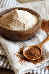 Teff flour in a bowl and teff grain with a spoon